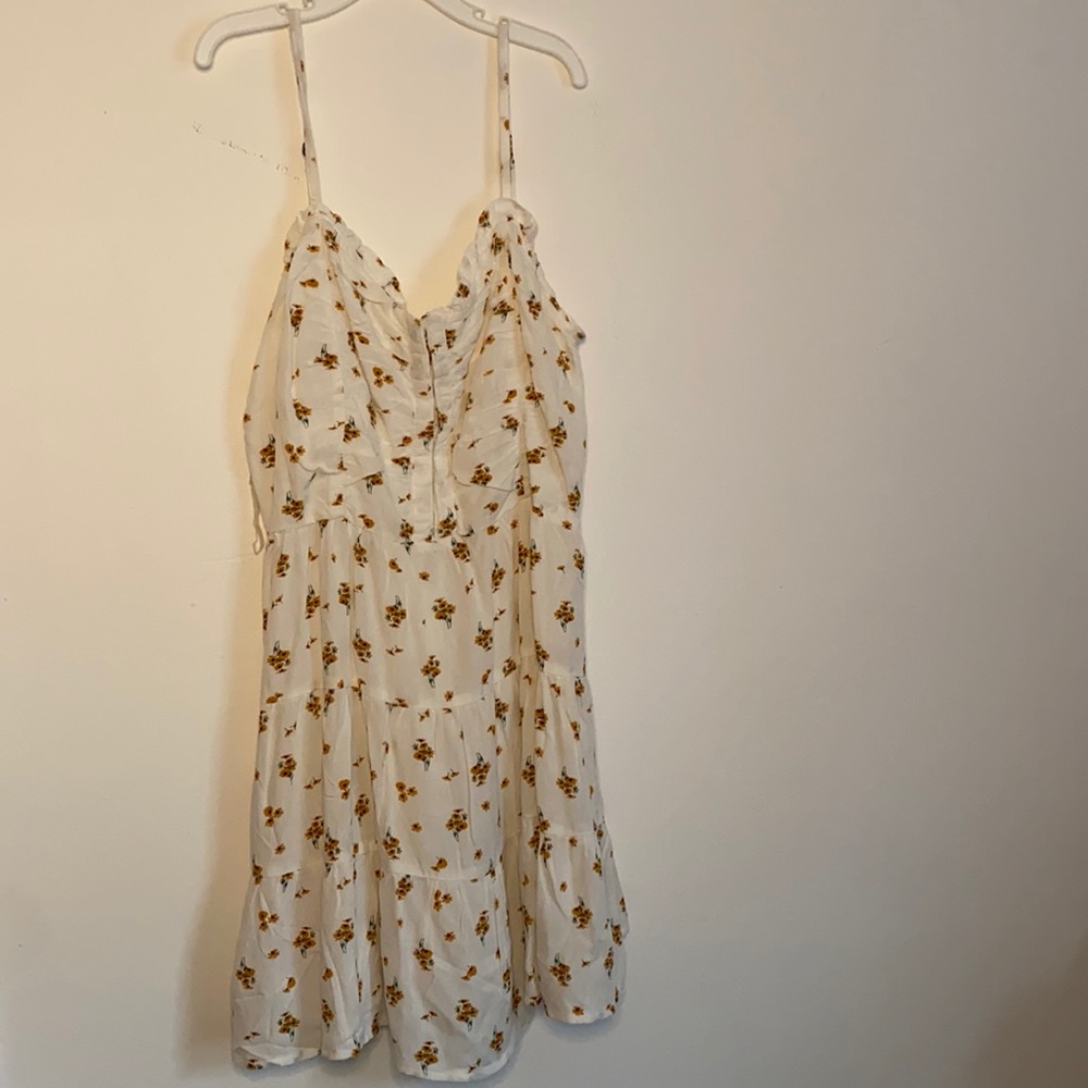 A white sundress with floral on it.